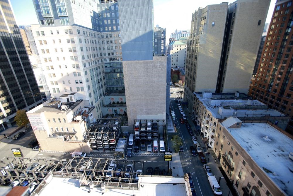 a view of a city street from a tall skyscraper