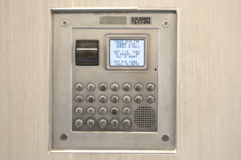 a metal atm machine with a screen on it