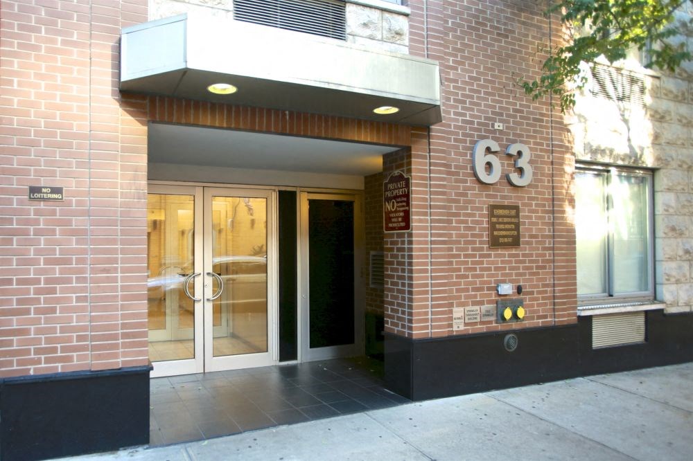 a brick building with a door and a number on it