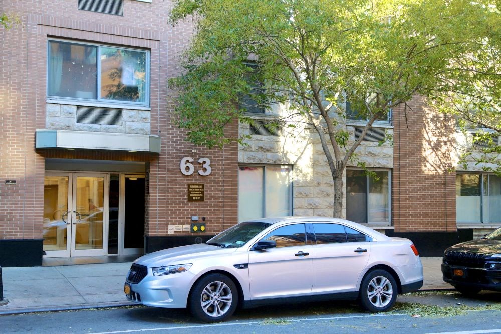 a white car parked in front of a building