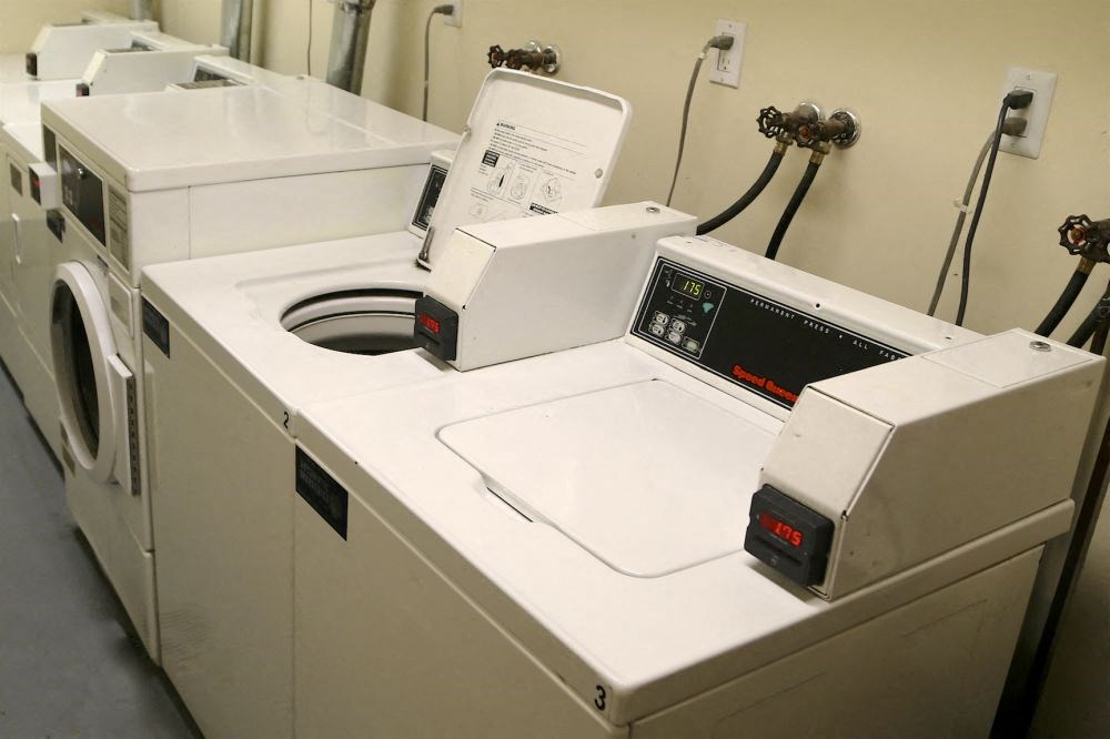 a row of washing machines and other appliances in a room