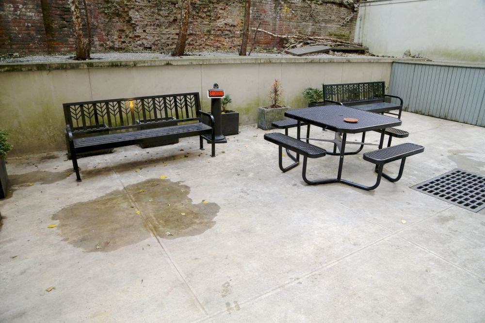 a patio with two benches and a table