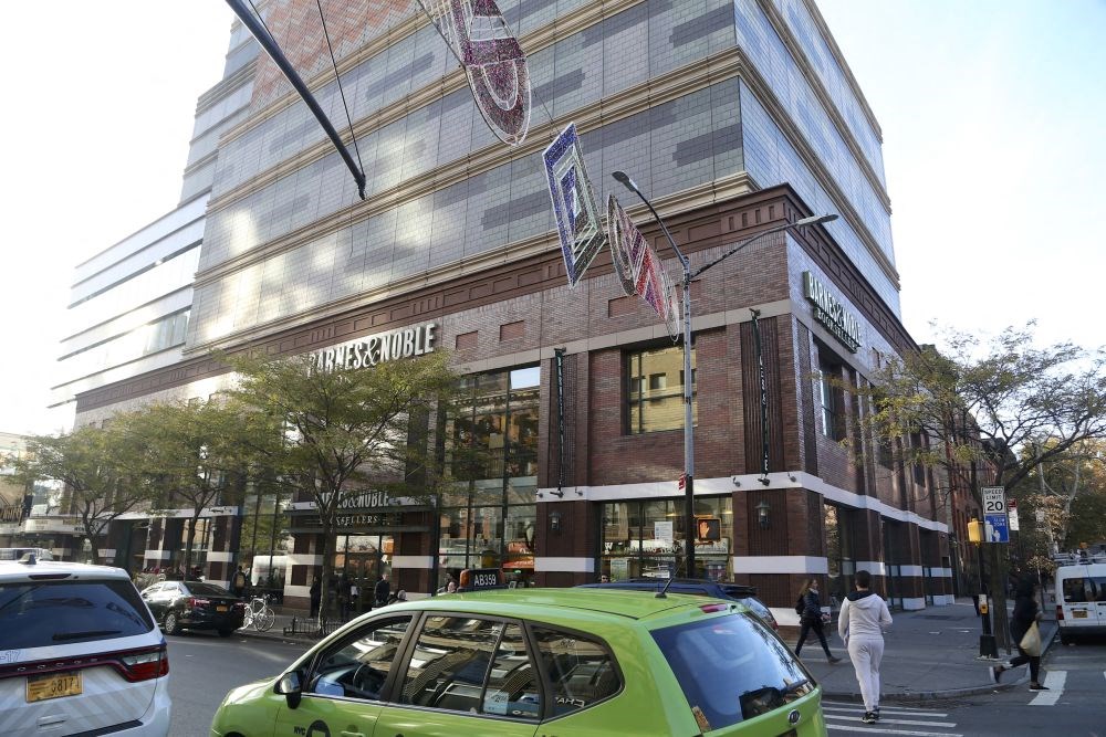 a busy street in front of a tall building