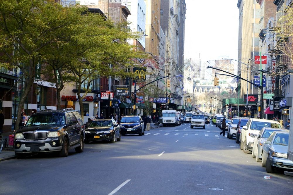 a busy city street filled with cars and buildings
