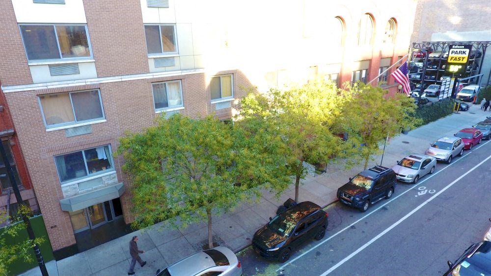 a street with cars parked in front of a building