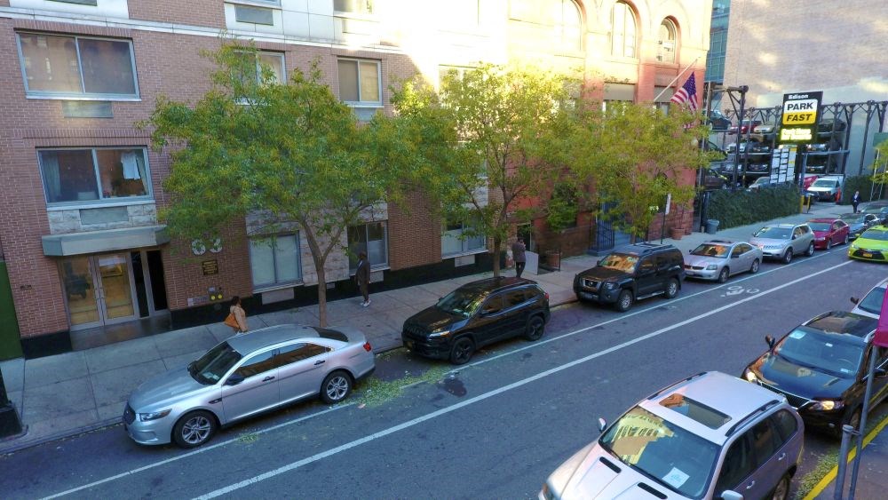 a city street with cars parked on the side of it