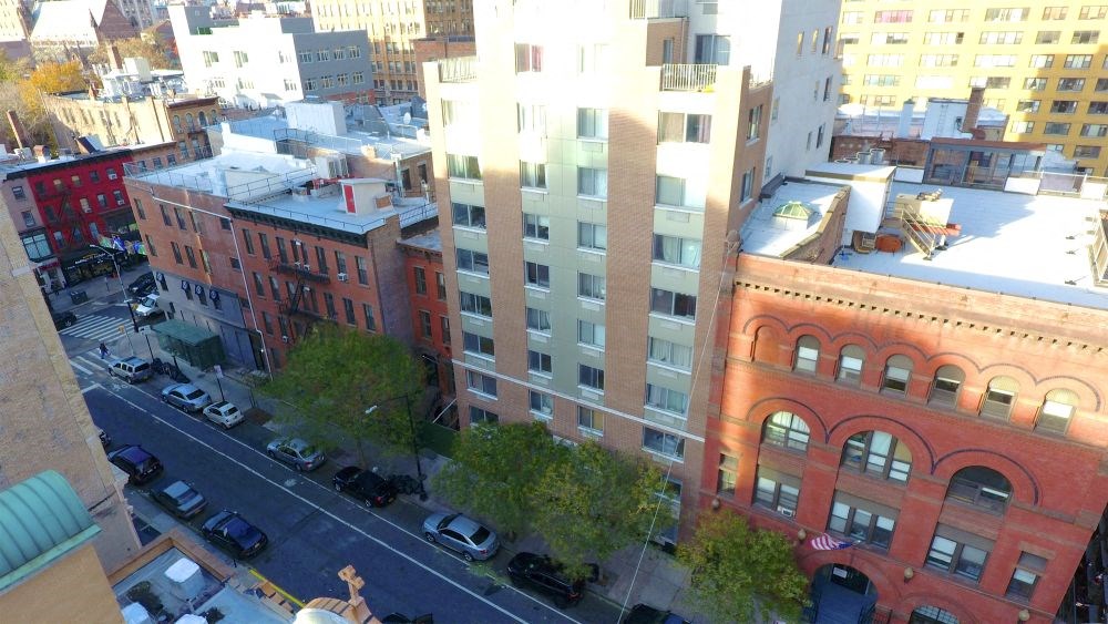 an aerial view of a city street and a tall building