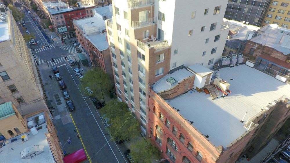 a view of a city street from the roof of a building