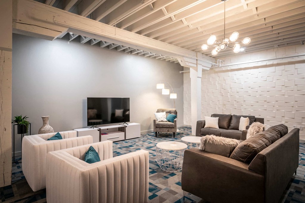 a living room with couches and chairs and a television