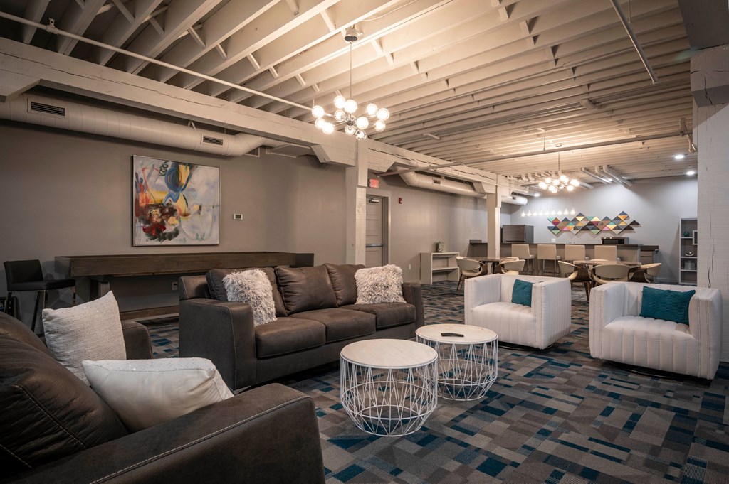 a living room with couches and chairs and tables