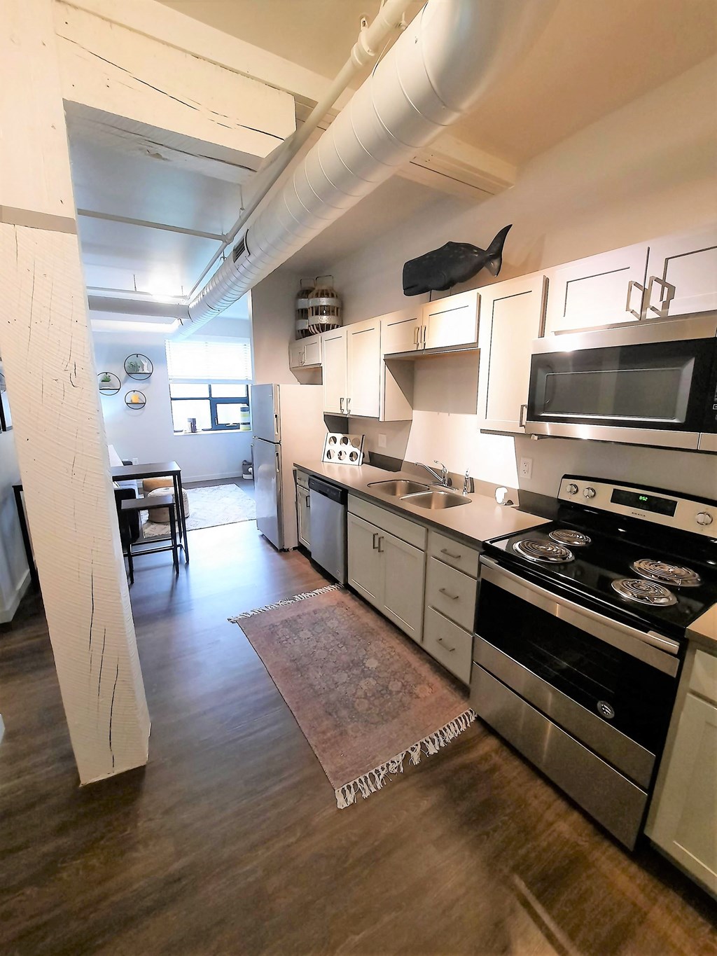 a kitchen with stainless steel appliances and white cabinets