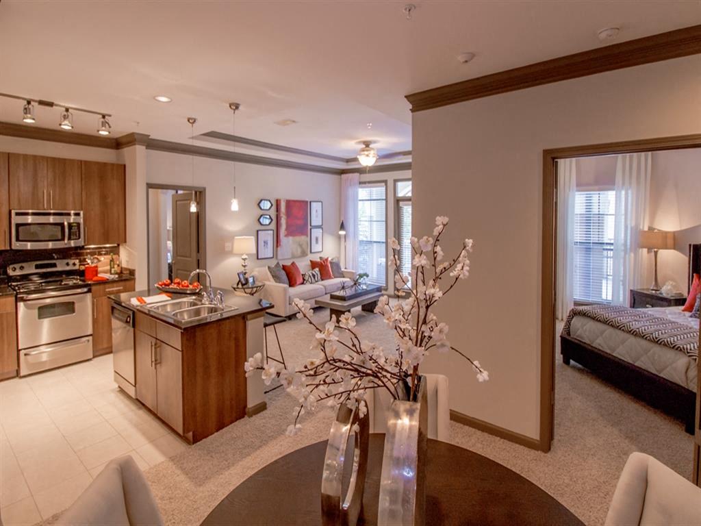 A modern kitchen with a dining table and chairs.