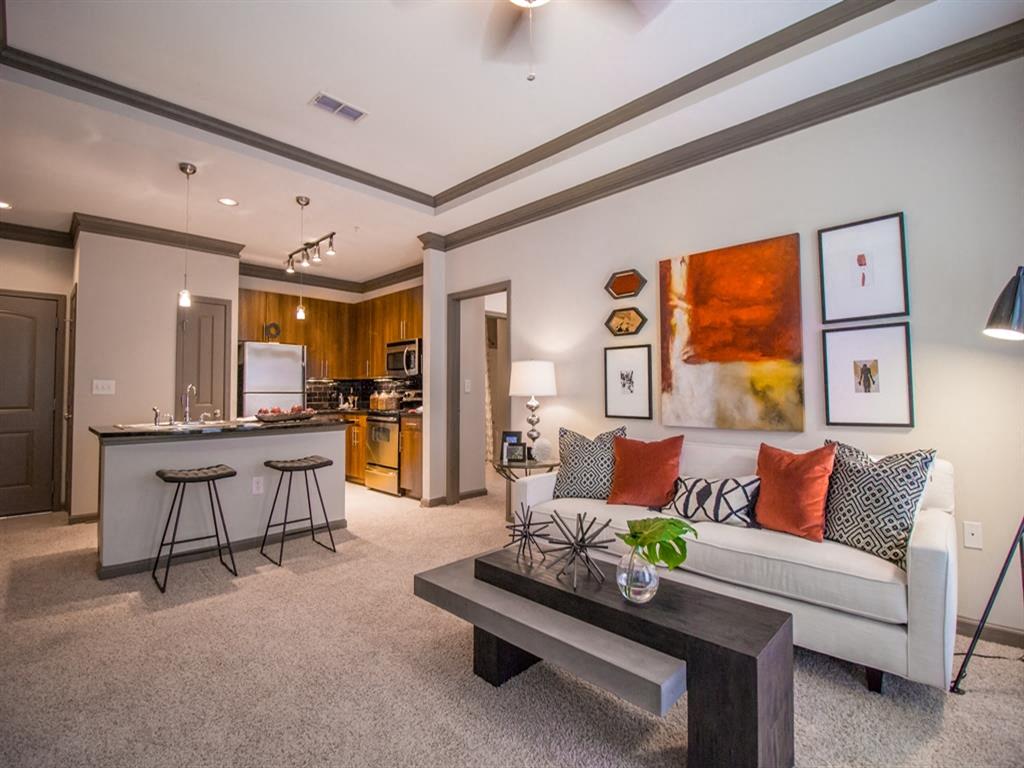A living room with a white couch and a bar area.
