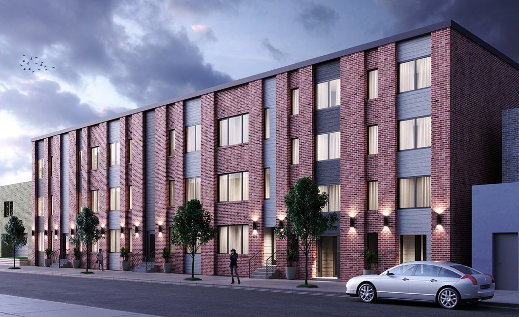 a large brick building with a car parked in front of it