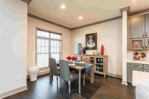 a dining room with a table and chairs and a window