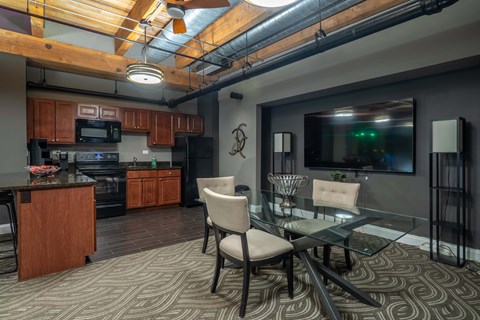 A modern kitchen with a glass table and chairs.