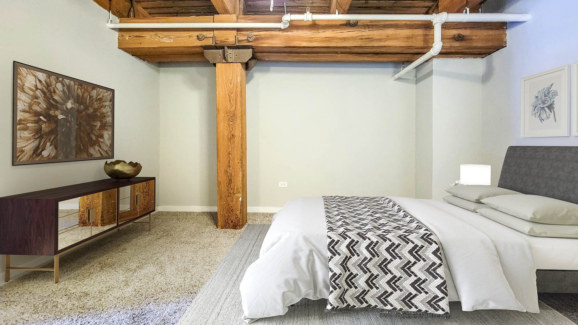 a bedroom with a bed and a wooden beam