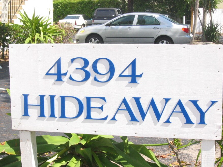 a sign that reads hidesway in front of a parking lot
