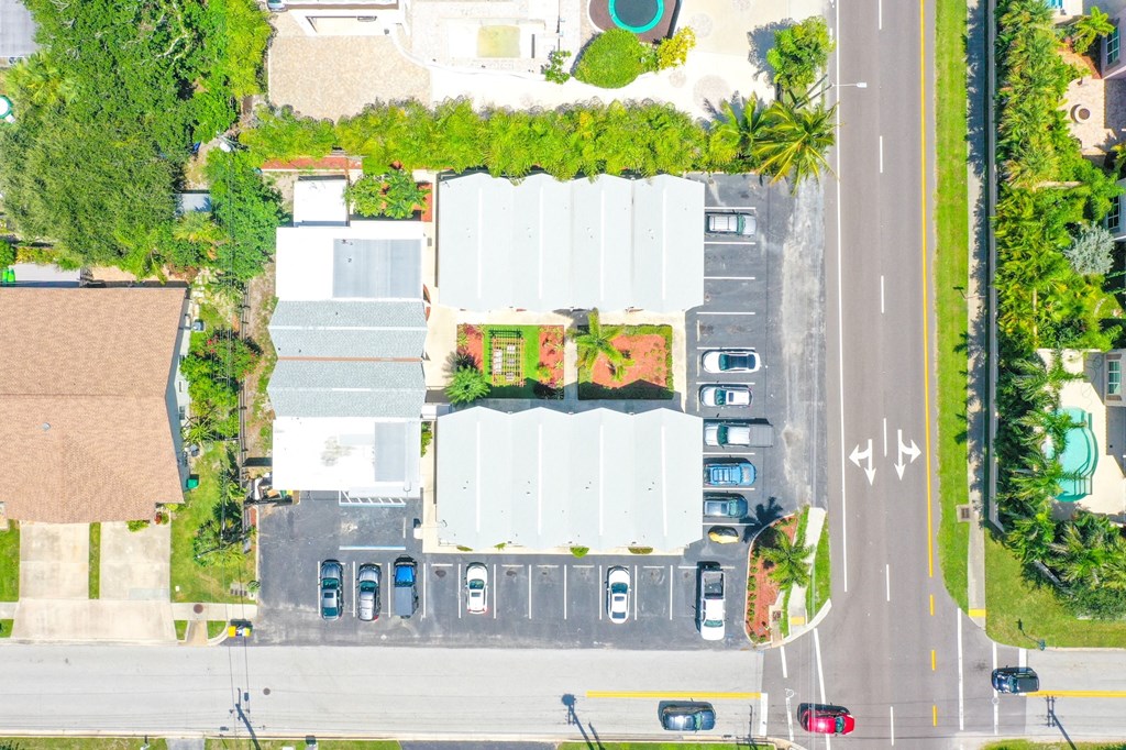 a birdseye view of a parking lot with cars on the street