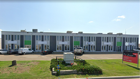 a large building with cars parked in front of it