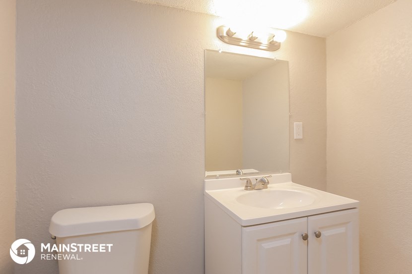 a bathroom with a sink and a mirror and a toilet