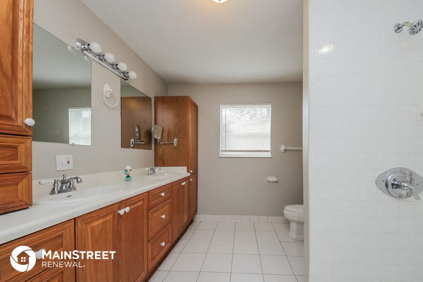 a bathroom with a sink and a toilet and a mirror