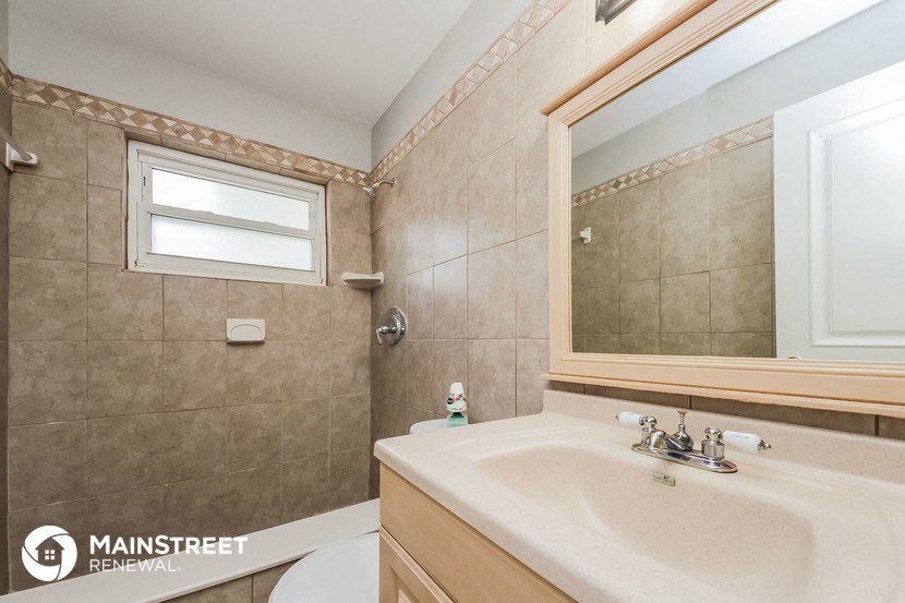 a bathroom with a sink and a mirror and a toilet