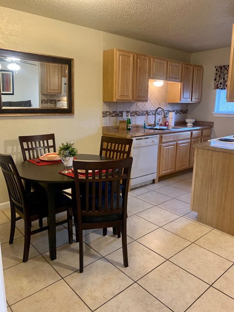 a kitchen with a table and chairs and a sink