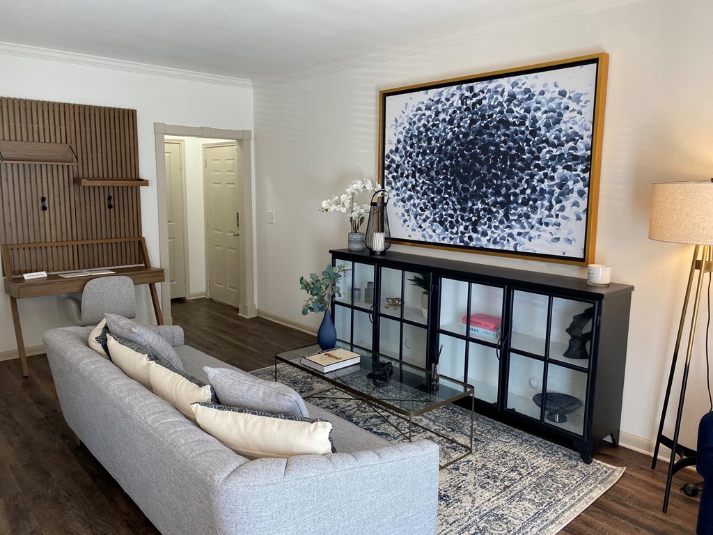 a living room with a couch and a large picture on the wall