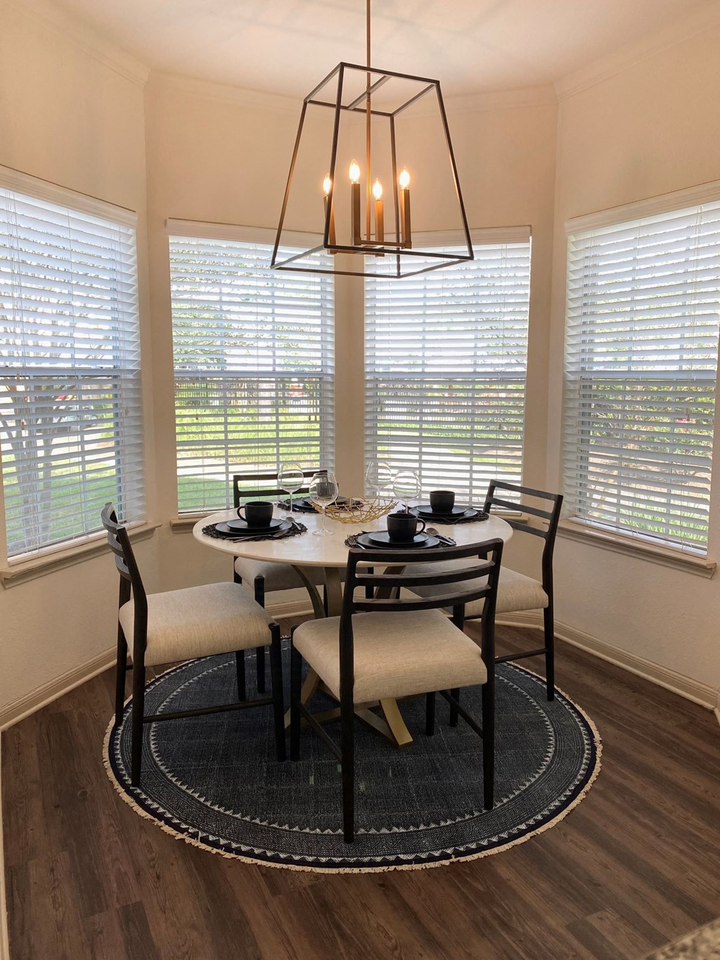 a dining room with a table and chairs and a chandelier
