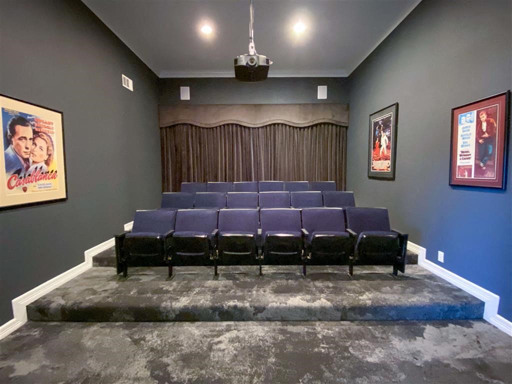 a small auditorium with blue seats and a stage