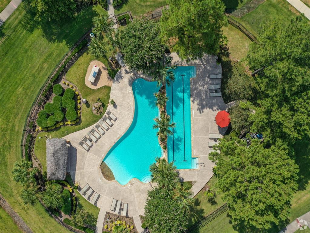 an overhead view of a swimming pool and a resort style pool