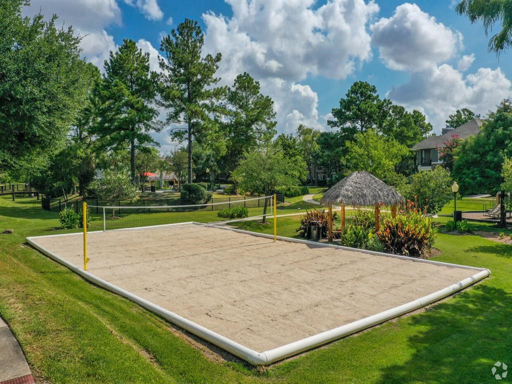 a large volleyball court in the middle of a grassy yard
