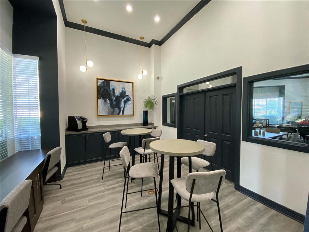 a dining room with tables and chairs and a window