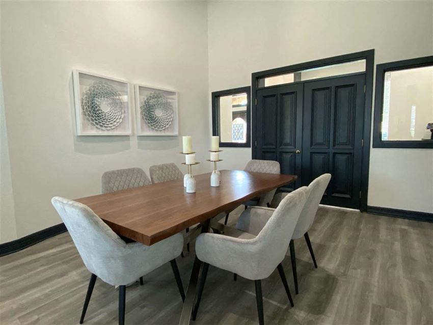 a dining room with a wooden table and chairs