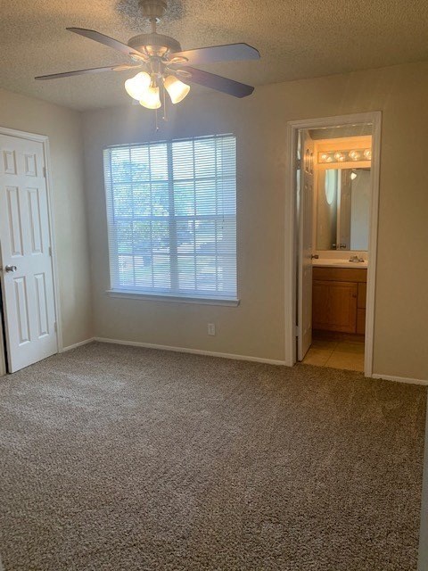 an empty room with a ceiling fan and a window