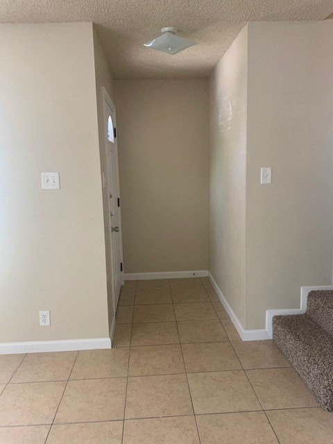 a hallway with a staircase and a door