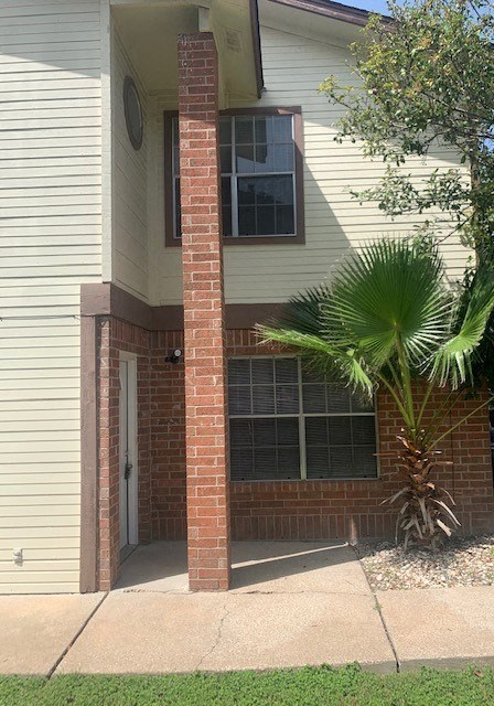 a white house with a palm tree in front of it