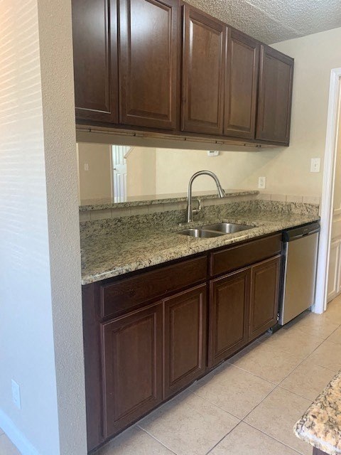 a kitchen with brown cabinets and a sink