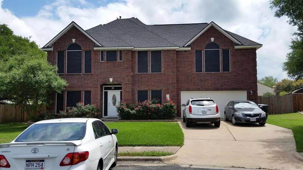 a house with three cars parked in front of it
