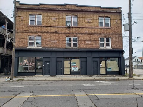 an old brick building on the side of a street