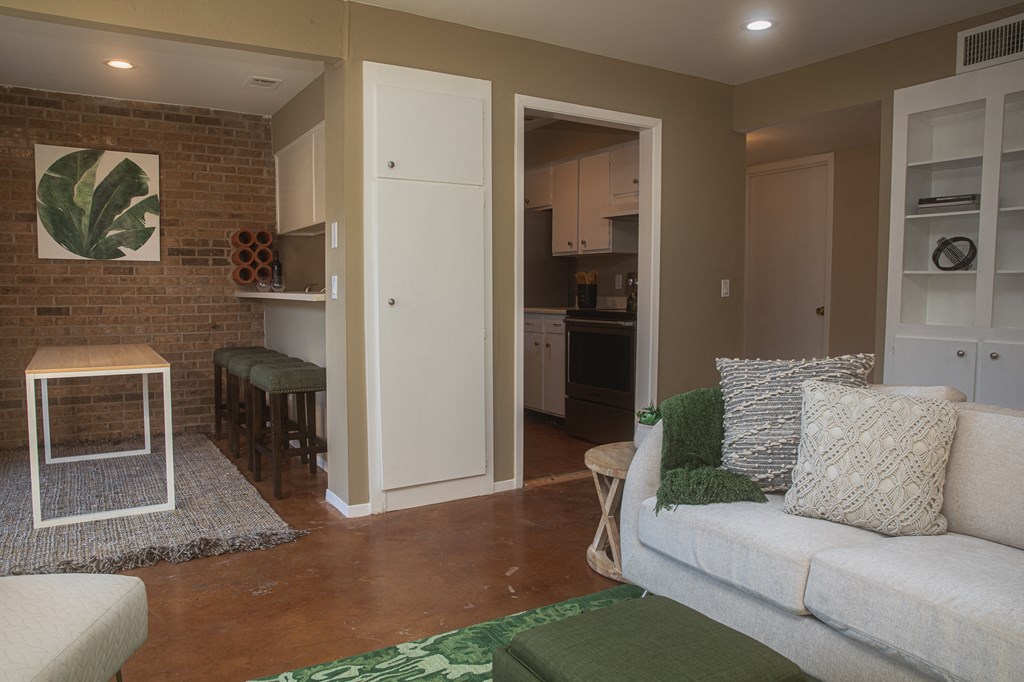 a living room and kitchen with a couch and a table