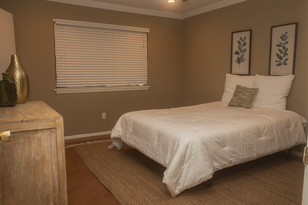 a bedroom with a bed and a window