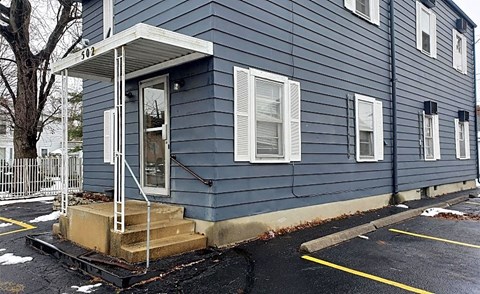 a blue house with steps and a porch