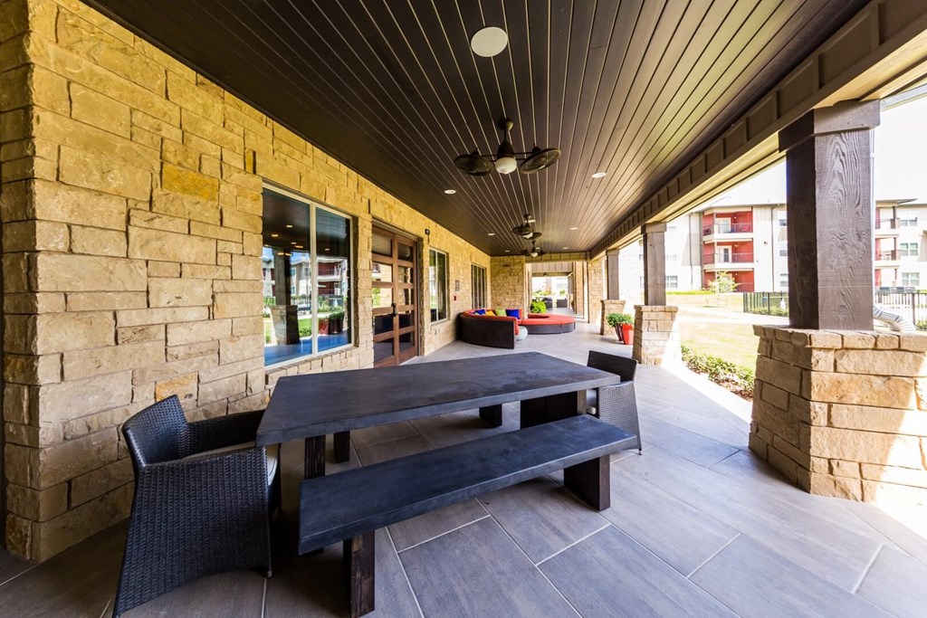 Outdoor Clubhouse Lounge Area with Large Bench at Legacy Creekside Apartments, San Antonio, Texas