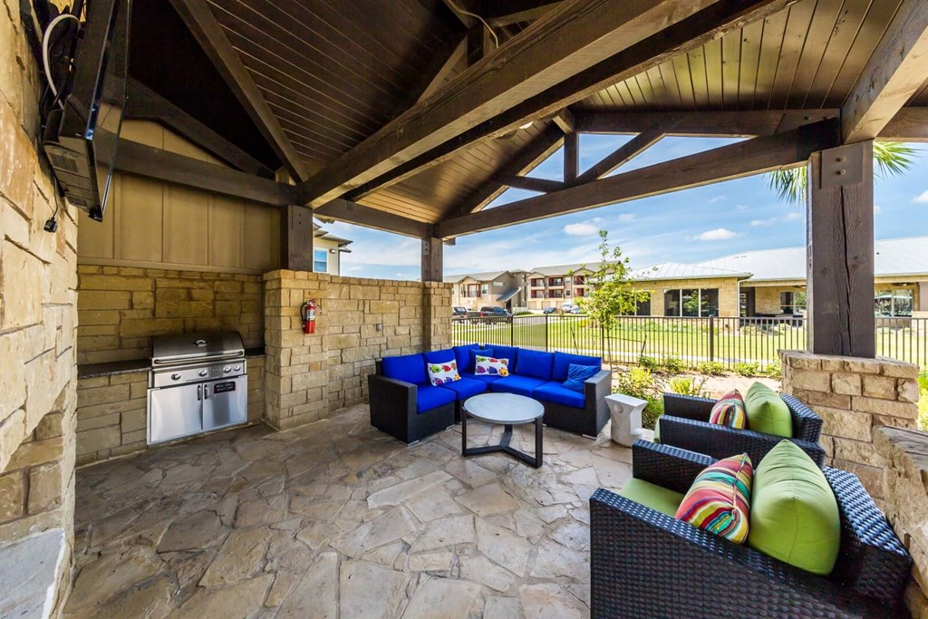 BBQ Area Inside Pool Area with Tables & Chairs at Legacy Creekside Apartments, San Antonio