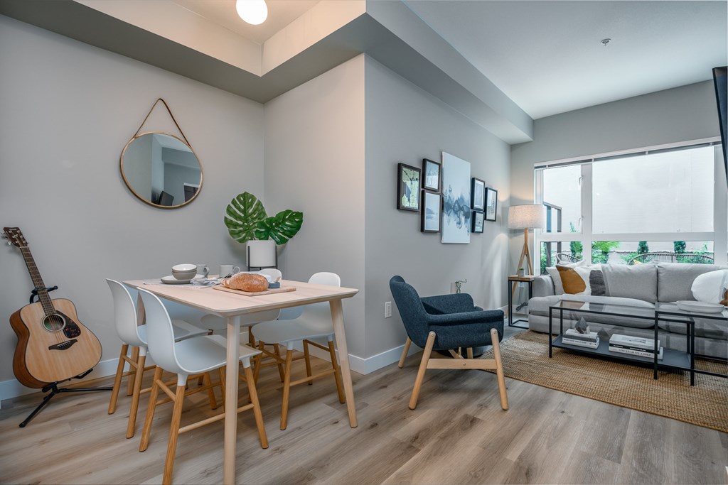 an open living room and dining room with a table and chairs