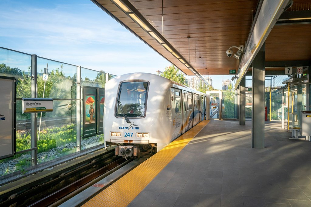 a white train pulling into a train station