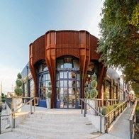 the facade of a building with trees and a staircase