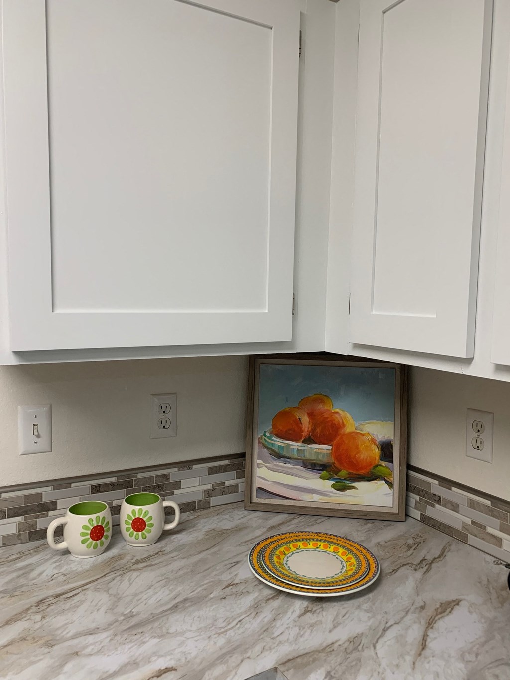 a box of oranges on the counter in a kitchen